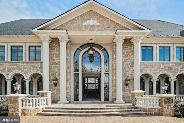 view of exterior entry with a porch