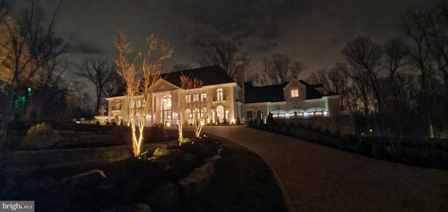 view of back house at twilight