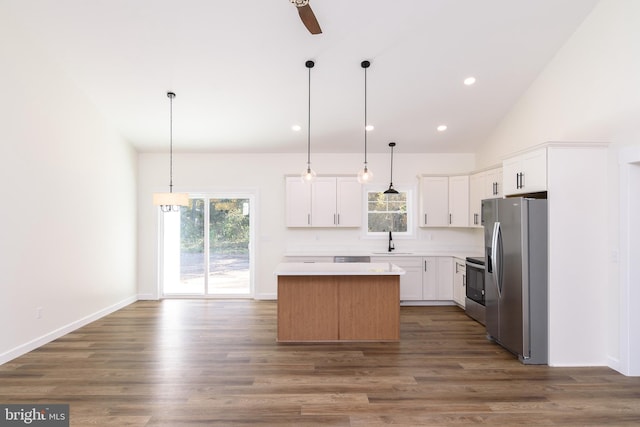 kitchen with white cabinetry, a healthy amount of sunlight, appliances with stainless steel finishes, and a kitchen island