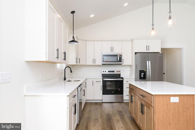 kitchen with white cabinetry, appliances with stainless steel finishes, and hanging light fixtures