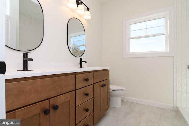 bathroom featuring vanity and toilet