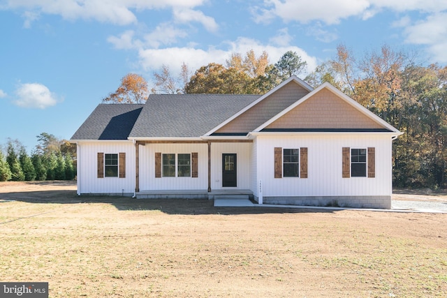 view of front of house featuring covered porch and a front lawn