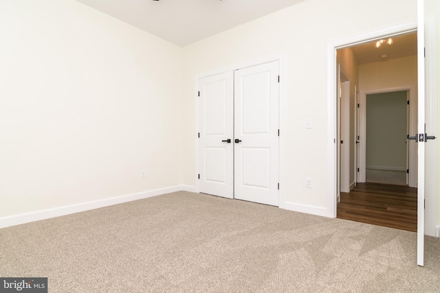 unfurnished bedroom with carpet flooring and a closet