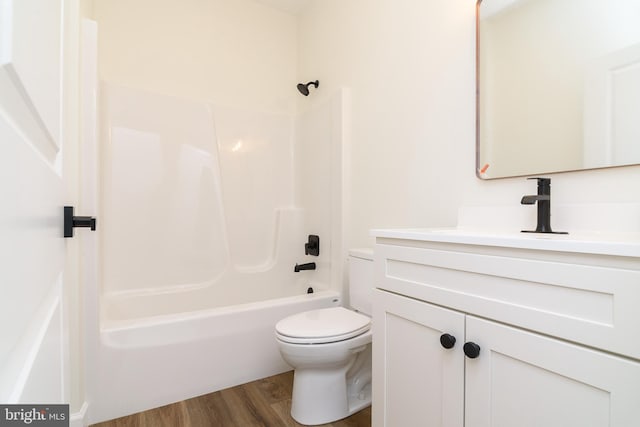 full bathroom featuring vanity, hardwood / wood-style flooring, toilet, and bathing tub / shower combination