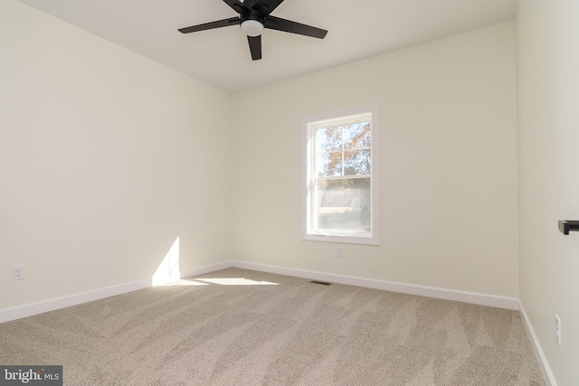 empty room featuring carpet flooring and ceiling fan