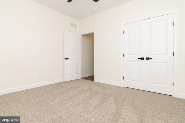 unfurnished bedroom featuring a closet, ceiling fan, and carpet floors