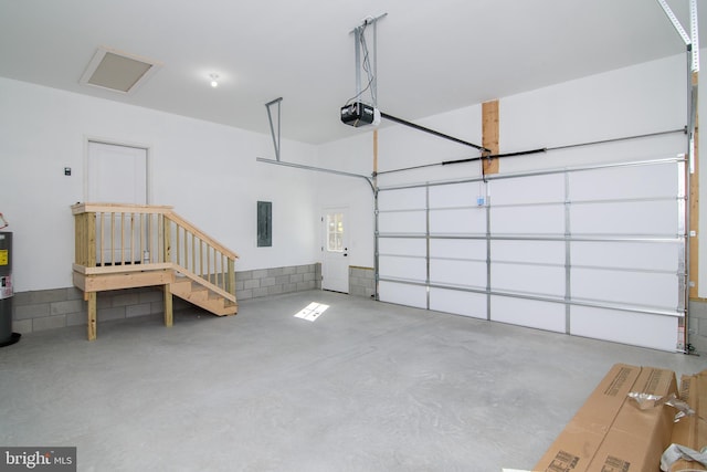 garage with electric panel, a garage door opener, and electric water heater