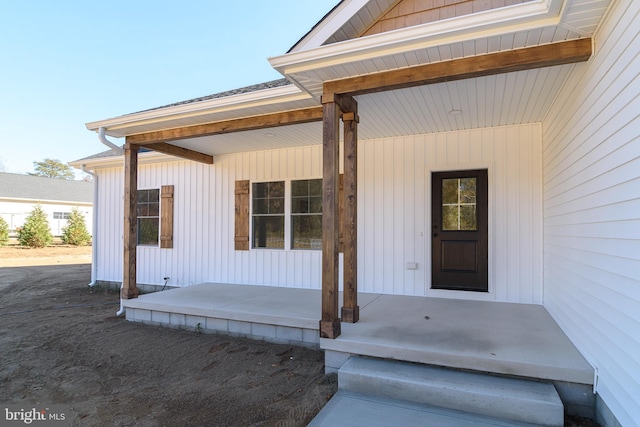 view of exterior entry with covered porch