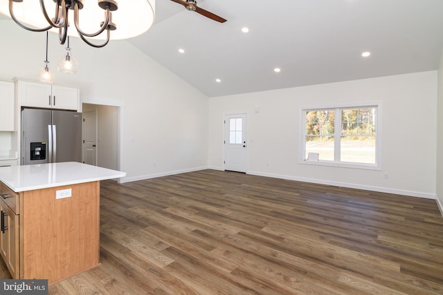 kitchen with a kitchen island, dark hardwood / wood-style flooring, white cabinets, high vaulted ceiling, and stainless steel fridge with ice dispenser