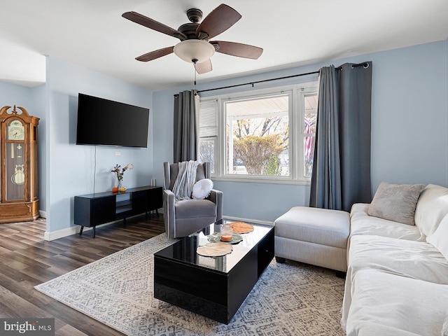 living room with dark wood-type flooring and ceiling fan