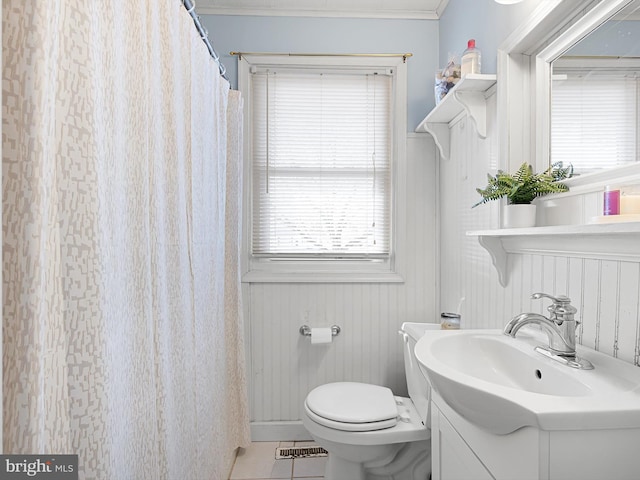 bathroom featuring curtained shower, toilet, vanity, ornamental molding, and tile patterned flooring