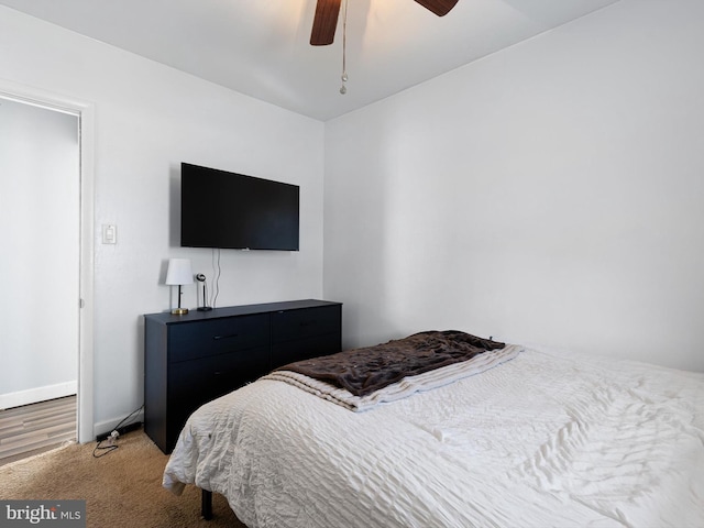 bedroom featuring light carpet and ceiling fan