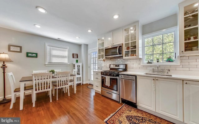 kitchen featuring white cabinetry, a healthy amount of sunlight, stainless steel appliances, and sink