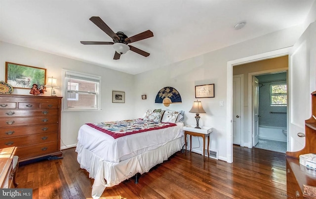 bedroom featuring dark wood-type flooring, multiple windows, and ceiling fan