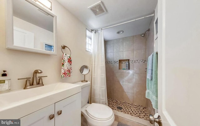 bathroom featuring vanity, a shower with shower curtain, and toilet