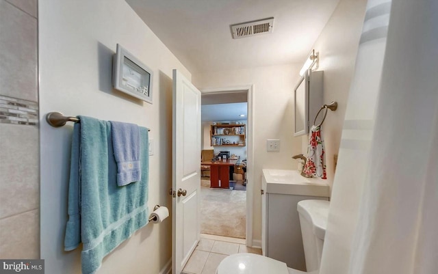 bathroom with vanity, toilet, and tile patterned floors