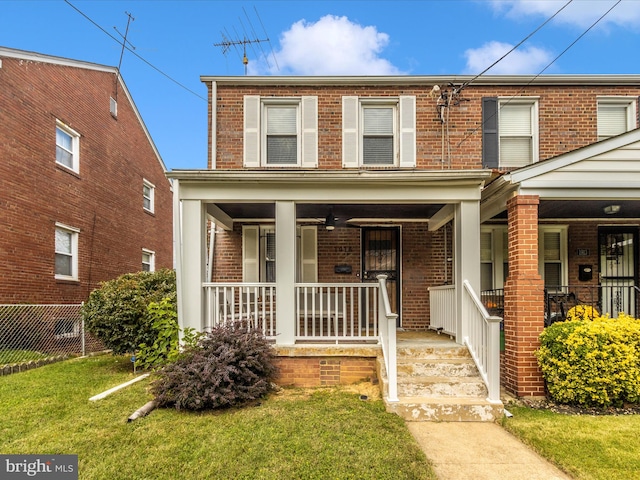 view of property with a front yard and covered porch