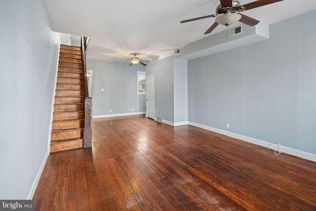 unfurnished living room featuring visible vents, baseboards, stairs, and hardwood / wood-style flooring