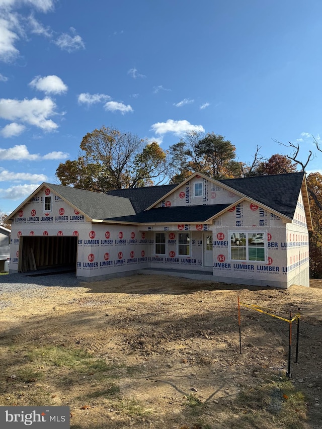 property under construction featuring an attached garage and driveway