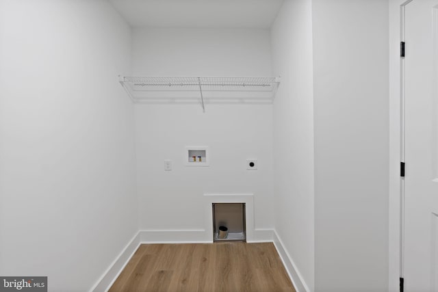 laundry area featuring hookup for an electric dryer, light hardwood / wood-style floors, and washer hookup