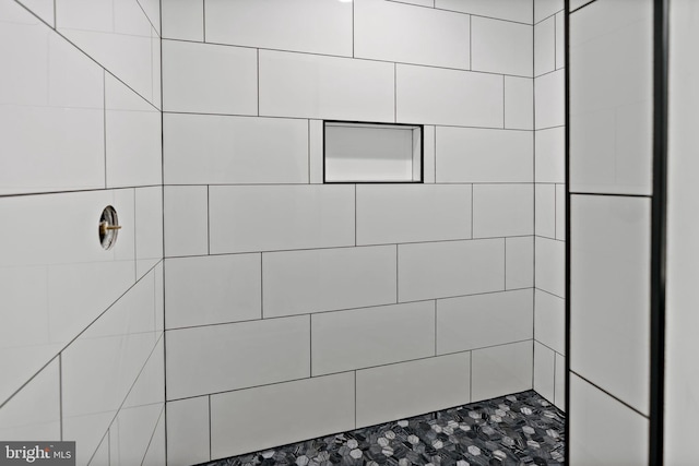 bathroom with a tile shower