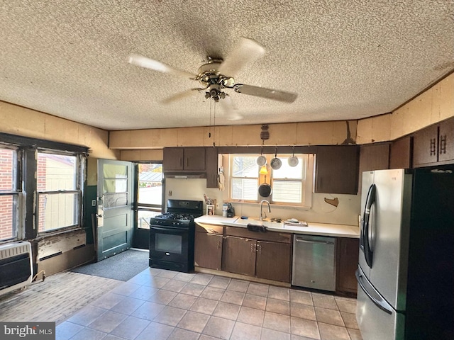 kitchen with dark brown cabinetry, stainless steel appliances, and ceiling fan