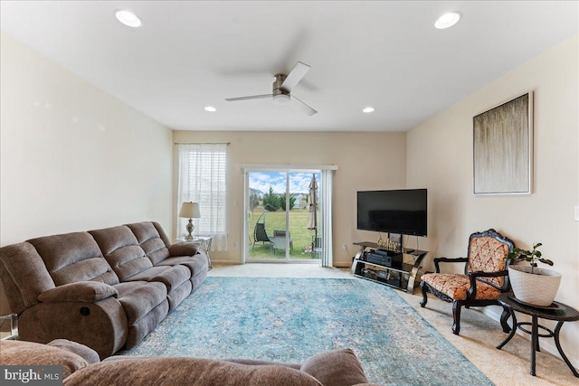 carpeted living room with ceiling fan