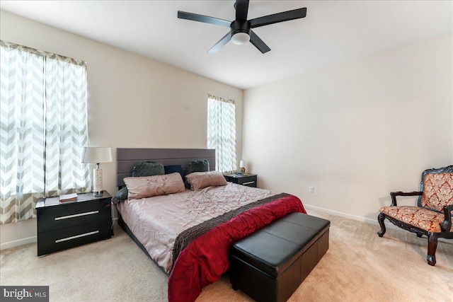 bedroom featuring ceiling fan and light colored carpet