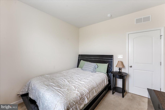 bedroom featuring light colored carpet