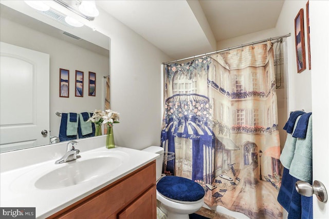 bathroom featuring vanity, a shower with shower curtain, and toilet