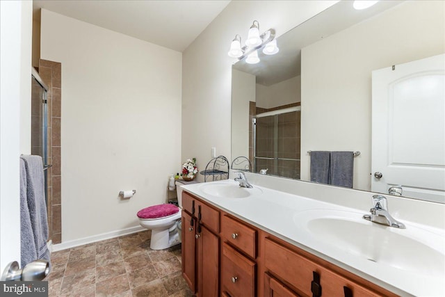 bathroom with vanity, toilet, and a shower with shower door