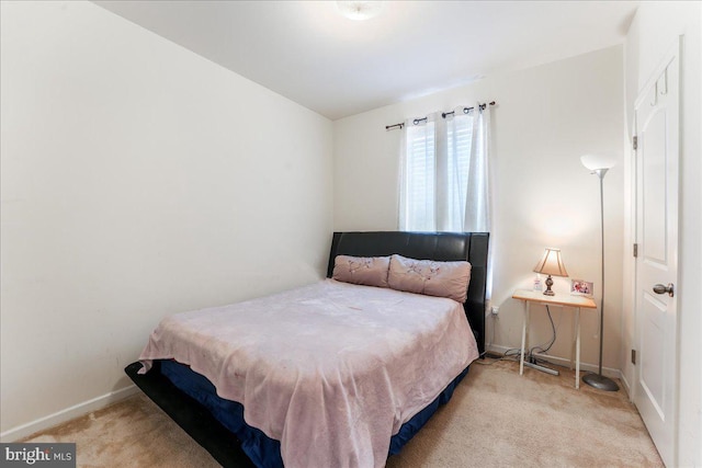 bedroom featuring light carpet