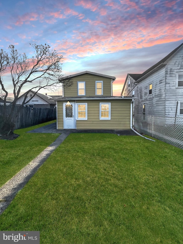 40 W Ridge St, Summit Hill, PA 18250 - back of property at dusk with fence and a lawn