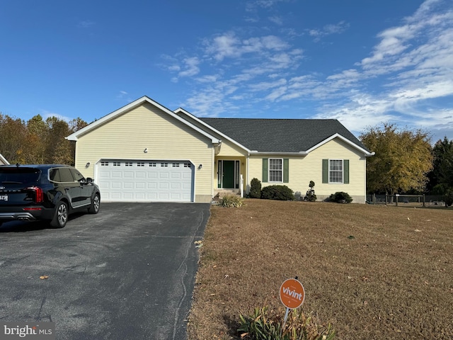 single story home with a garage and a front lawn