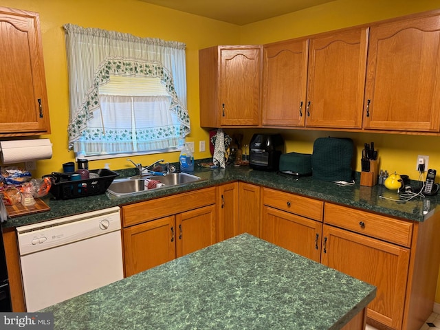 kitchen with white dishwasher and sink