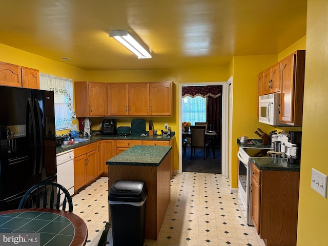 kitchen with a center island and white appliances