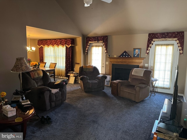 living room featuring carpet flooring, ceiling fan with notable chandelier, and vaulted ceiling