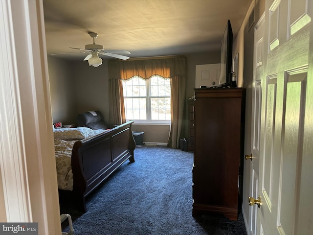 bedroom featuring dark carpet and ceiling fan