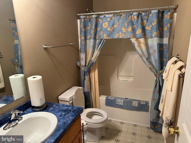 bathroom with vanity, a shower with shower curtain, and toilet