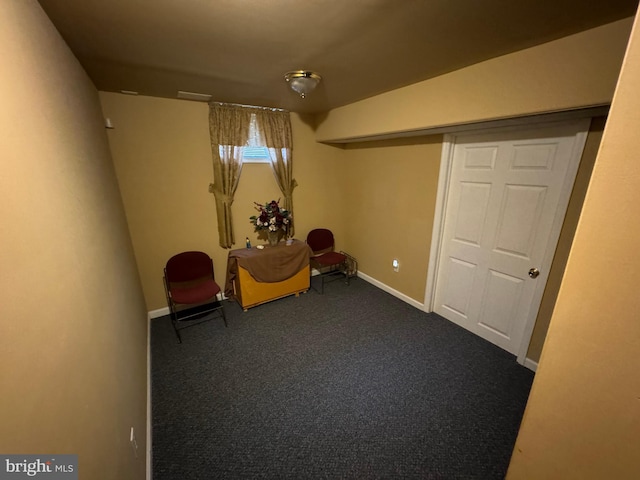 unfurnished room featuring dark carpet