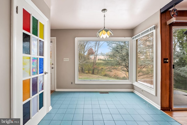 unfurnished dining area with light tile patterned floors