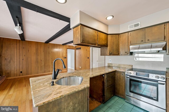 kitchen featuring stainless steel electric range, dark hardwood / wood-style flooring, light stone countertops, sink, and kitchen peninsula