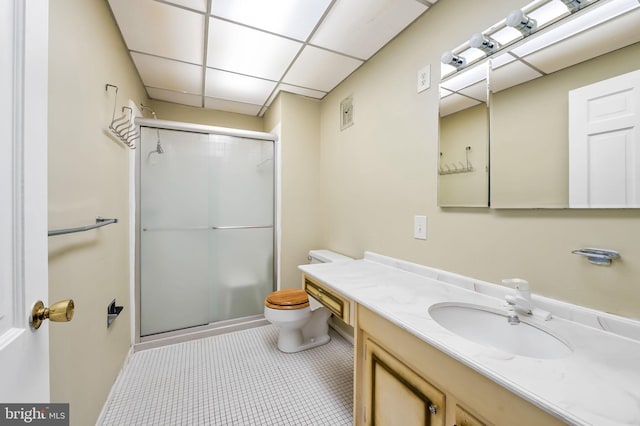 bathroom featuring walk in shower, vanity, toilet, and tile patterned floors