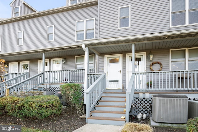 view of front of home with central AC unit and a porch