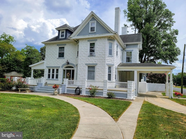 victorian home featuring a front lawn and covered porch