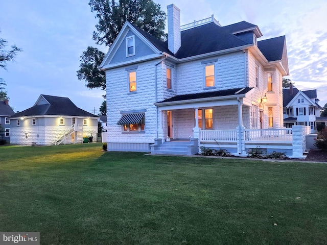 back of house featuring a yard