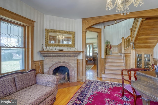 living area featuring wood-type flooring and a fireplace