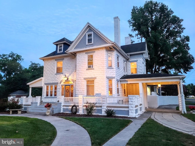 view of front of property with a porch and a front yard