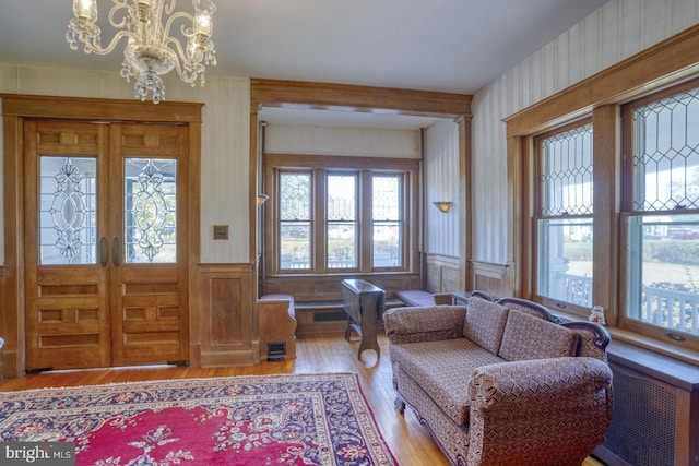 foyer entrance with hardwood / wood-style flooring and a chandelier