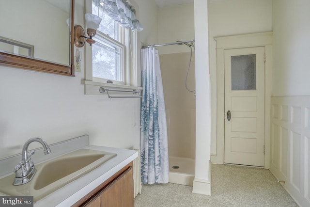 bathroom featuring vanity and curtained shower